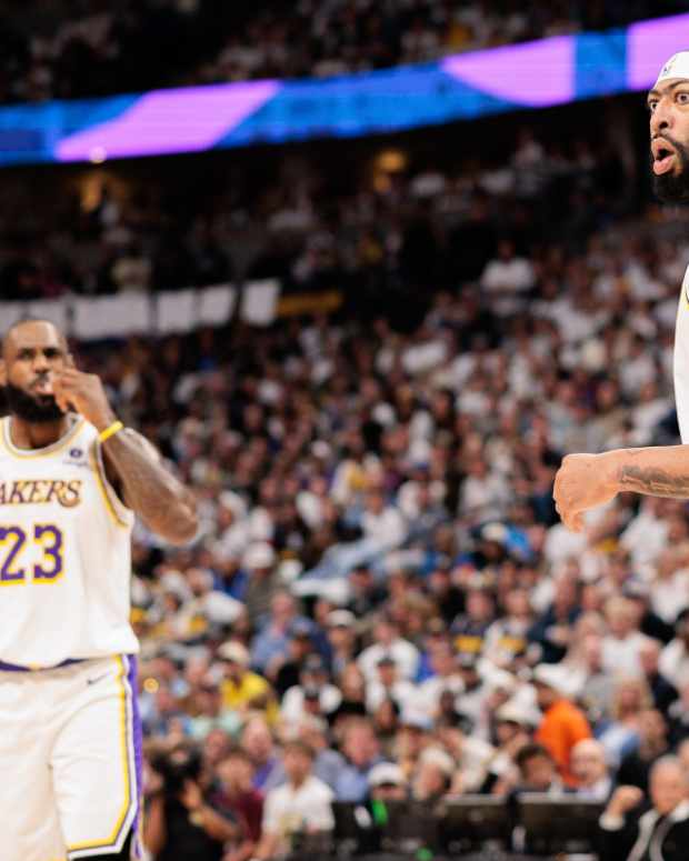 Los Angeles Lakers forward Anthony Davis (3) and forward LeBron James (23) react during the first quarter against the Denver Nuggets in game one of the first round for the 2024 NBA playoffs at Ball Arena.
