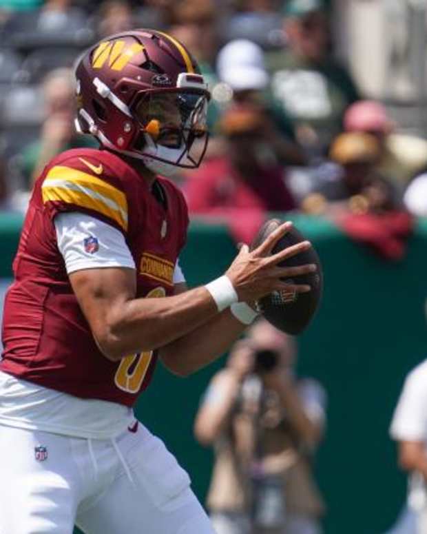 Aug 10, 2024; East Rutherford, New Jersey, USA; Washington Commanders quarterback Marcus Mariota (0) receives a snap during the first quarter against the New York Jets at MetLife Stadium. Mandatory Credit: Lucas Boland-USA TODAY Sports