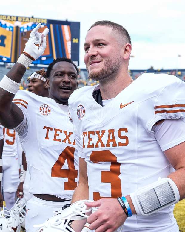 Texas quarterback Quinn Ewers and teammates celebrate their win over Michigan.