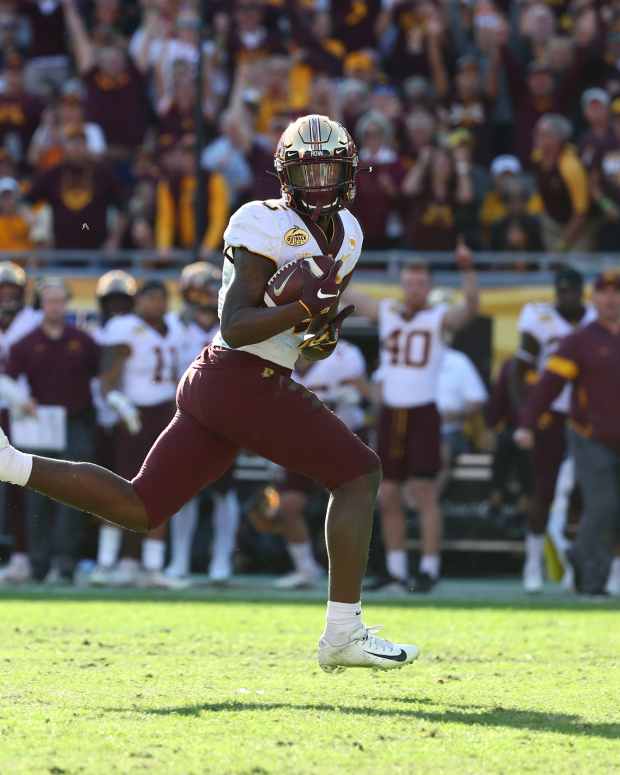 Jan 1, 2020; Tampa, Florida, USA; Minnesota Golden Gophers wide receiver Tyler Johnson (6) carries the ball to score a touchdown against the Auburn Tigers during the second half at Raymond James Stadium.