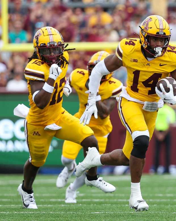 Sep 14, 2024; Minneapolis, Minnesota, USA; Minnesota Golden Gophers defensive back Kerry Brown (14) runs the ball after intercepting a pass against the Nevada Wolf Pack during the first half at Huntington Bank Stadium.