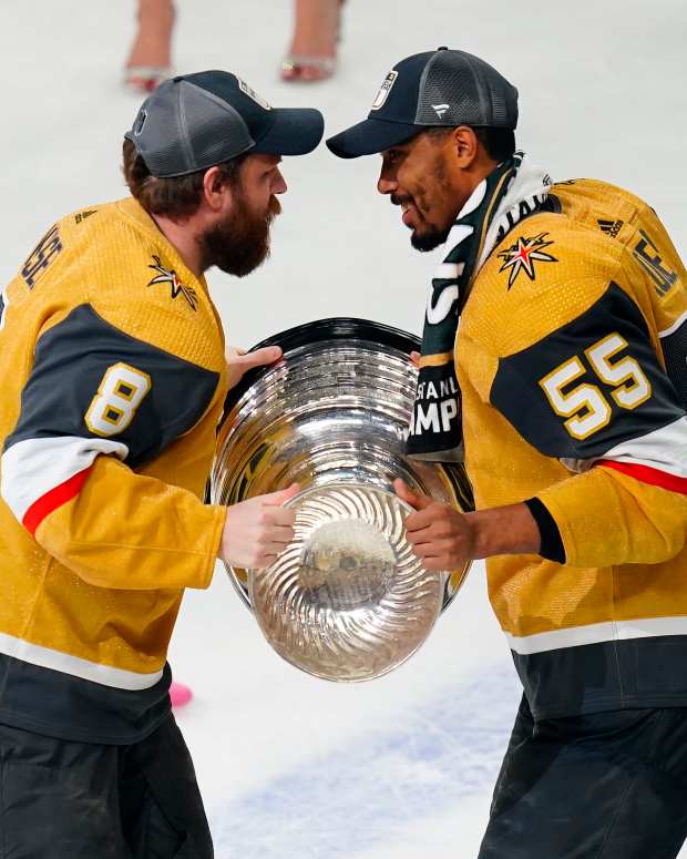 Vegas Golden Knights forward Phil Kessel (8) hands the Stanley Cup to forward Keegan Kolesar (55) after winning the 2023 championship.