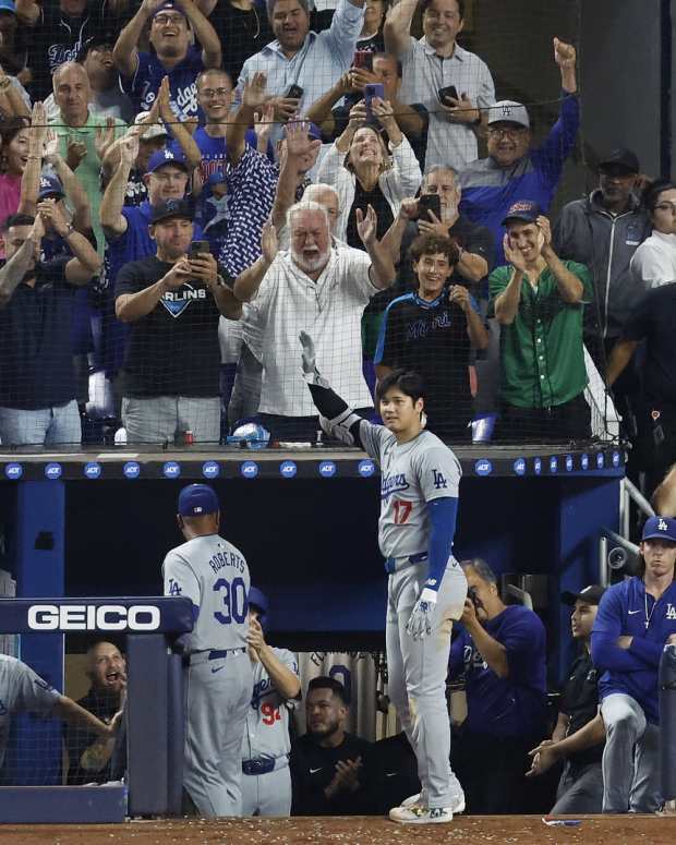 Miami, Florida, USA; Los Angeles Dodgers designated hitter Shohei Ohtani (17) reacts to a standing ovation from the fans after hitting his 50th home run of the season against the Miami Marlins during the seventh inning at loanDepot Park - Rhona Wise-Imagn Images