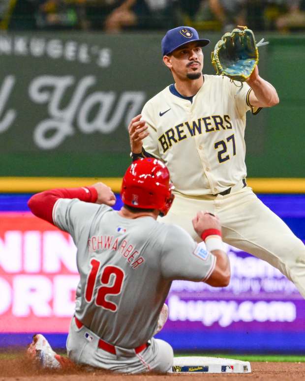 Sep 18, 2024; Milwaukee, Wisconsin, USA; Milwaukee Brewers shortstop Willy Adames (27) forces out Philadelphia Phillies designated hitter Kyle Schwarber (12) in the eighth inning at American Family Field.