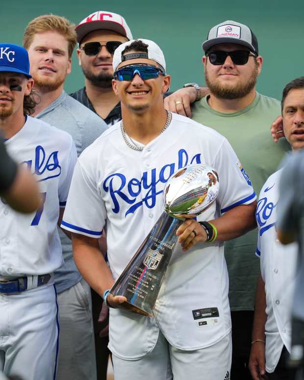 Kansas City Chiefs quarterback Patrick Mahomes poses for a photo with teammates prior to a game between the Cincinnati Reds and the Kansas City Royals at Kauffman Stadium. 