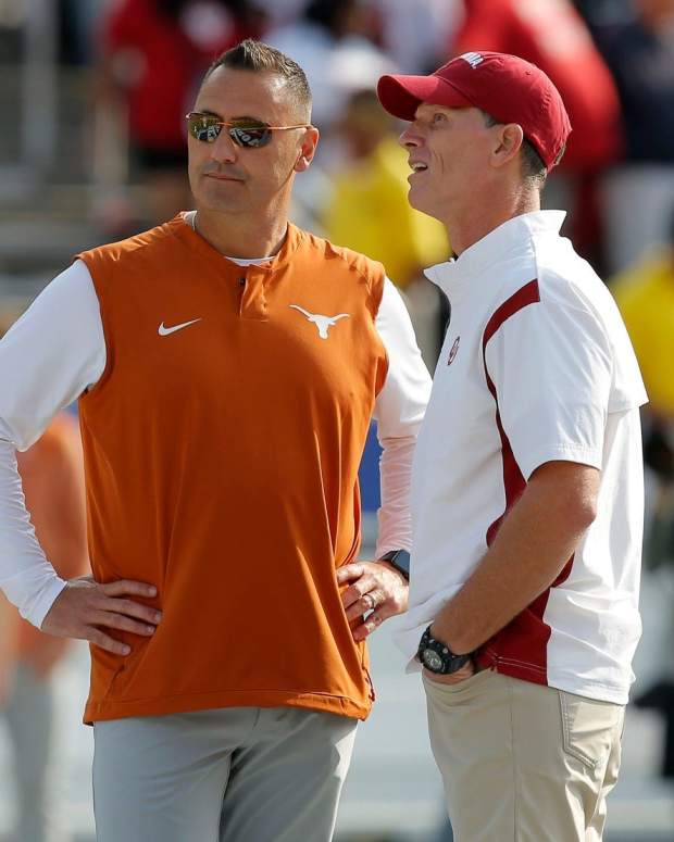 Oklahoma Sooners head coach Brent Venables, at right, and Texas Longhorns head coach Steve Sarkisian talk before the Red River Showdown college football game between the University of Oklahoma (OU) and Texas at the Cotton Bowl in Dallas, Saturday, Oct. 8, 2022.