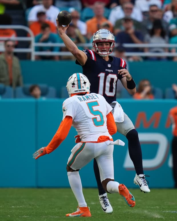 Nov 24, 2024; Miami Gardens, Florida, USA; New England Patriots quarterback Drake Maye (10) attempts a pass over Miami Dolphins cornerback Jalen Ramsey (5) during the second half at Hard Rock Stadium.