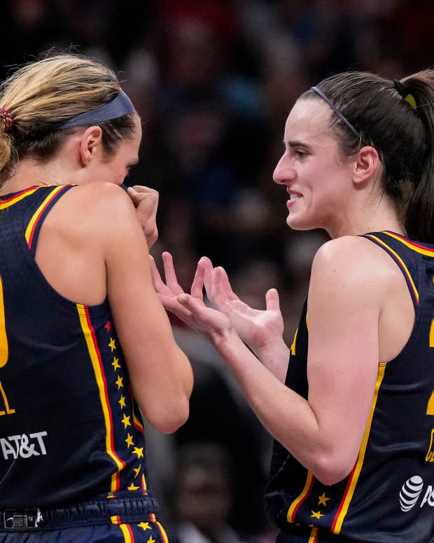 Indiana Fever guard Caitlin Clark talks with teammate Lexie Hull.