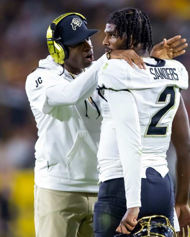 Colorado Buffaloes head coach Deion Sanders with son and quarterback Shedeur Sanders (2) against the Arizona State Sun Devils at Mountain America Stadium.