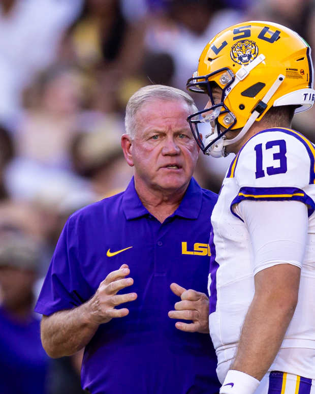 LSU Tigers quarterback Garrett Nussmeier (13) talks to head coach Brian Kelly.