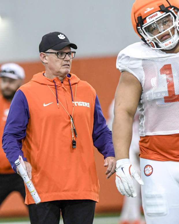 Clemson defensive coordinator Tom Allen near defensive lineman Peter Woods (11) during the football practice at the Allen N. Reeves Football Complex at Clemson University