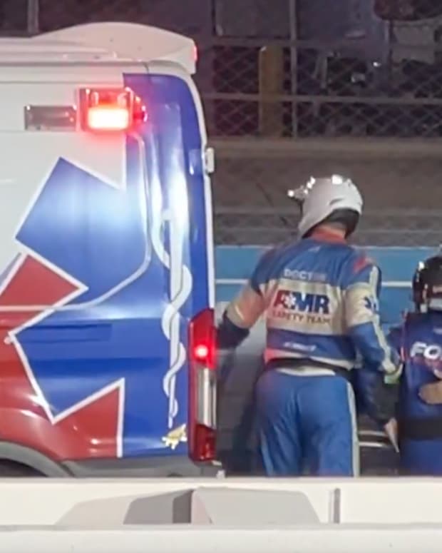 Frankie Muniz leaves the track in an ambulance.