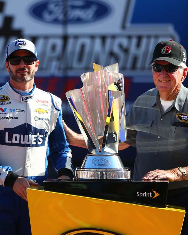 Nov 20, 2016; Homestead, FL, USA; NASCAR Sprint Cup Series driver Jimmie Johnson (left) greets former driver and Hall of Fame member Bobby Allison during the Ford Ecoboost 400 at Homestead-Miami Speedway. Mandatory Credit: Mark J. Rebilas-Imagn Images  