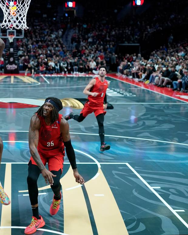 Nov 12, 2024; Portland, Oregon, USA; Minnesota Timberwolves center Naz Reid (11) goes up for a dunk against Portland Trail Blazers small forward Jerami Grant (9) during the first half at Moda Center.