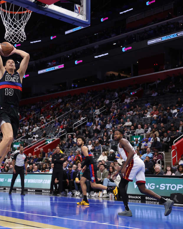 Simone Fontecchio of the Detroit Pistons dunks in the Nike Freak 6 NRG EP ‘Roses’ in front of Tyler Herro of the Miami Heat in the Nike Sabrina 2 ‘By You' during the second half in the first round of the Emirates NBA Cup at Little Caesars Arena