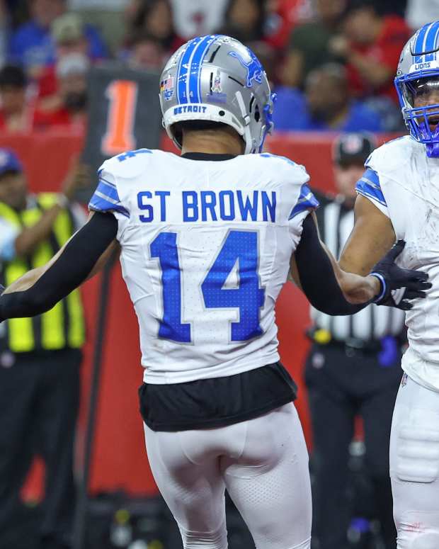 Nov 10, 2024; Houston, Texas, USA; Detroit Lions running back David Montgomery (5) celebrates with wide receiver Amon-Ra St. Brown (14) after scoring a touchdown during the third quarter against the Houston Texans at NRG Stadium.