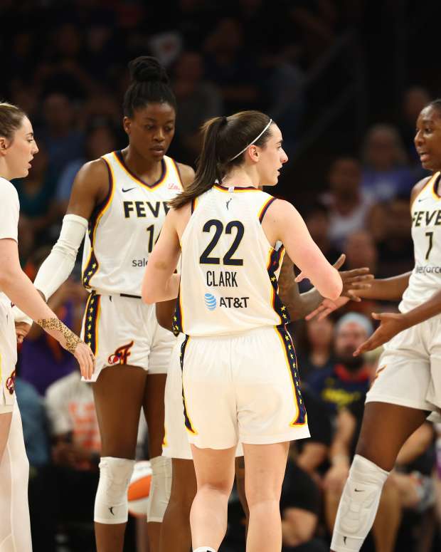 Indiana Fever guard Caitlin Clark (22) in the huddle with forward Katie Lou Samuelson (33), center Temi Fagbenle (14) and forward Aliyah Boston (7).