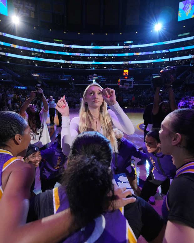 The Los Angeles Sparks huddle around Cameron Brink at Crypto.com Arena.