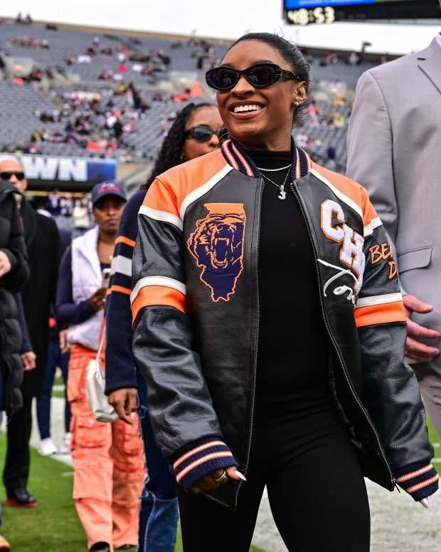 Star gymnast Simone Biles looks on before the game at Soldier Field.