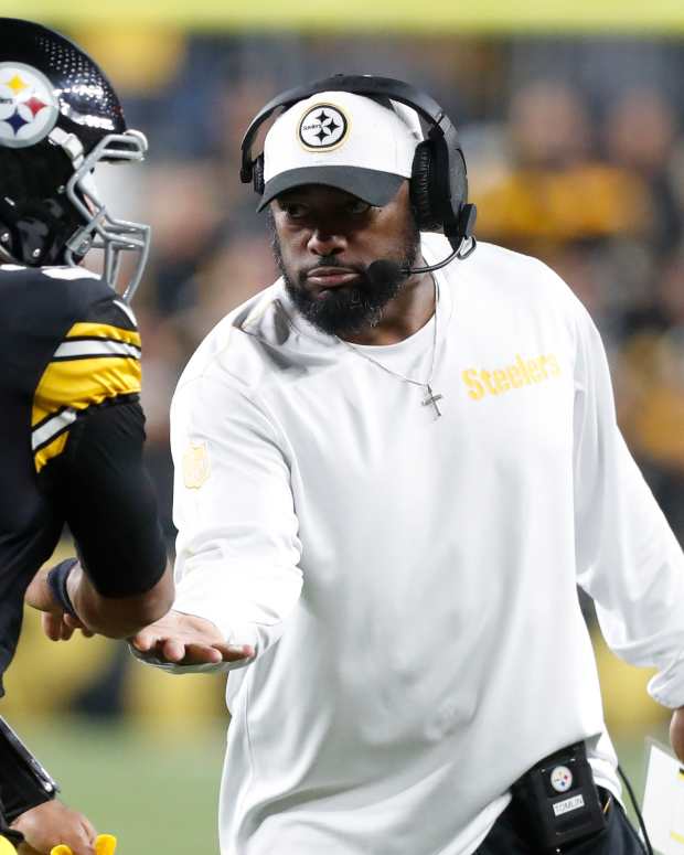 Pittsburgh Steelers coach Mike Tomlin congratulates quarterback Russell Wilson at Acrisure Stadium.