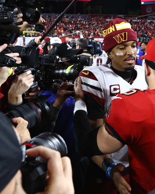 Washington Commanders quarterback Jayden Daniels (5) greets Tampa Bay Buccaneers quarterback Baker Mayfield (6).