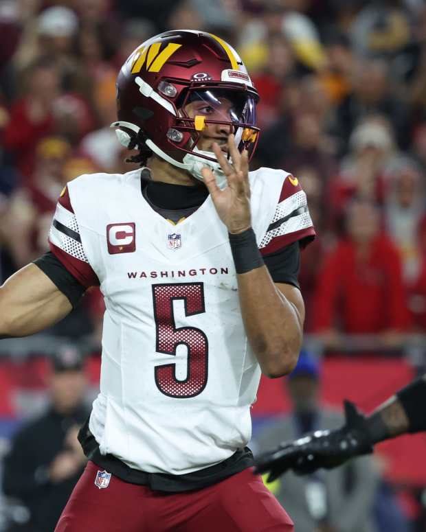 Washington Commanders quarterback Jayden Daniels throws during the second quarter at Raymond James Stadium.