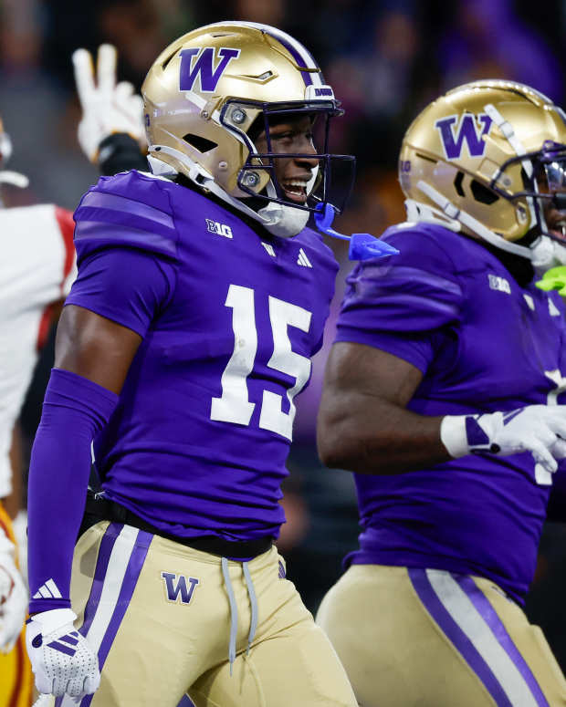 Nov 2, 2024; Seattle, Washington, USA; Washington Huskies wide receiver Keith Reynolds (15) celebrates after rushing for a touchdown against the USC Trojans during the fourth quarter at Alaska Airlines Field at Husky Stadium.