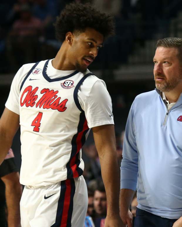 Mississippi Rebels head coach Chris Beard (right) talks with forward Jaemyn Brakefield (4).