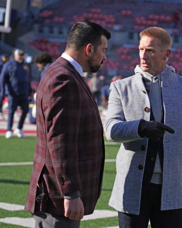 Ohio State University football coach Ryan Day talks with broadcaster Joel Klatt prior to the Michigan game.