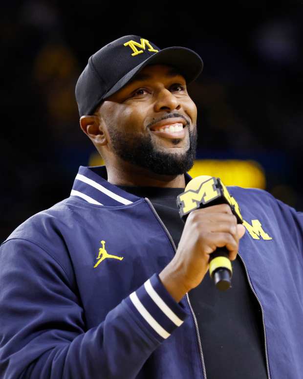 Sherrone Moore speaks at the Michigan vs. Northwestern basketball game on January 19.