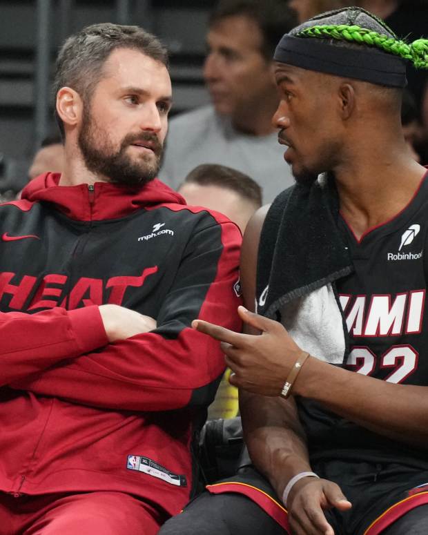 Miami Heat forward Jimmy Butler (right) talks with forward Kevin Love (left).