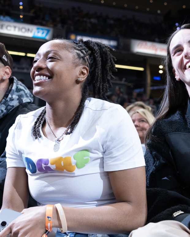 Indiana Fever guards Caitlin Clark (right) and Kelsey Mitchell (left) at an Indiana Pacers game at Gainbridge Fieldhouse.