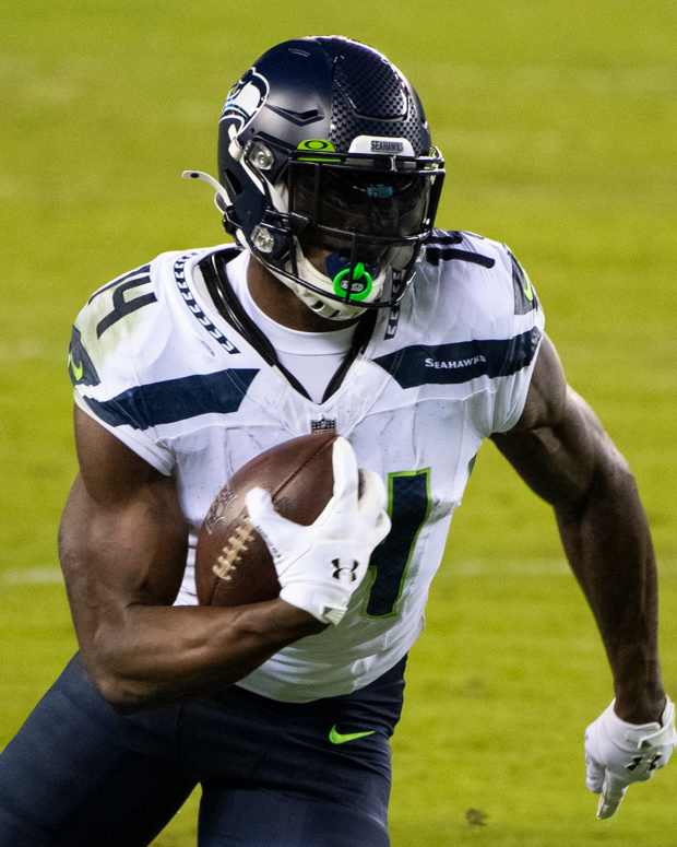 Seahawks' D.K. Metcalf (14) carries the ball against the Eagles.