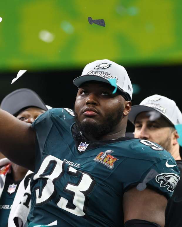 Philadelphia Eagles defensive tackle Milton Williams celebrates on the podium after defeating the Kansas City Chiefs in Super Bowl LIX at the Superdome in New Orleans.