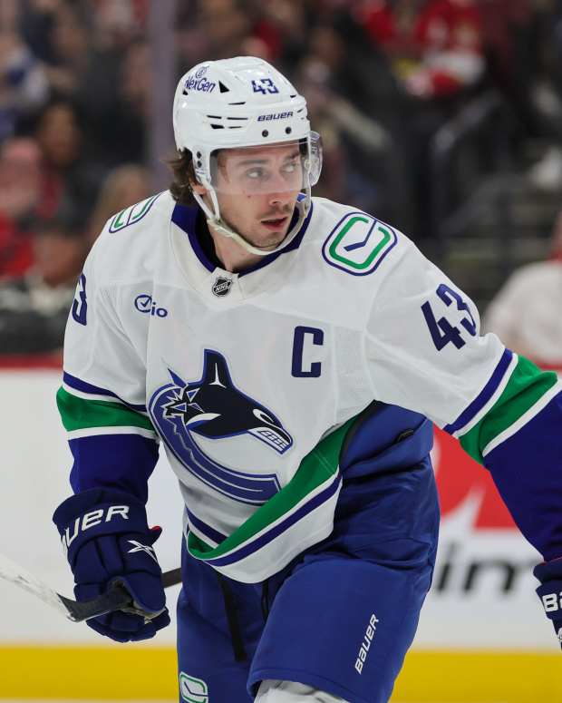 Vancouver Canucks defenseman Quinn Hughes (43) looks on after scoring a goal.
