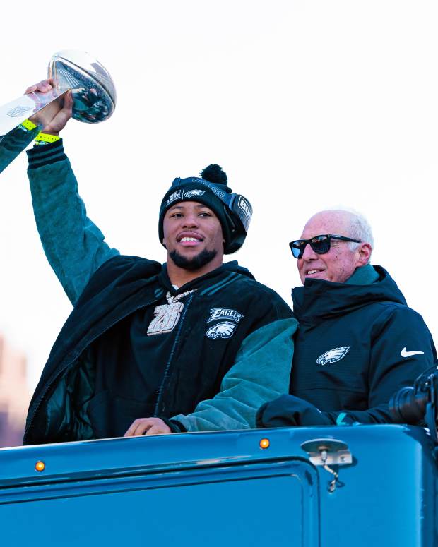 Philadelphia Eagles running back Saquon Barkley (26) lifts the Lombardi Trophy during the Super Bowl LIX championship parade.