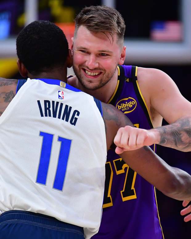 Los Angeles Lakers guard Luka Doncic (77) reacts with Dallas Mavericks guard Kyrie Irving (11) during the first quarter at Crypto.com Arena.