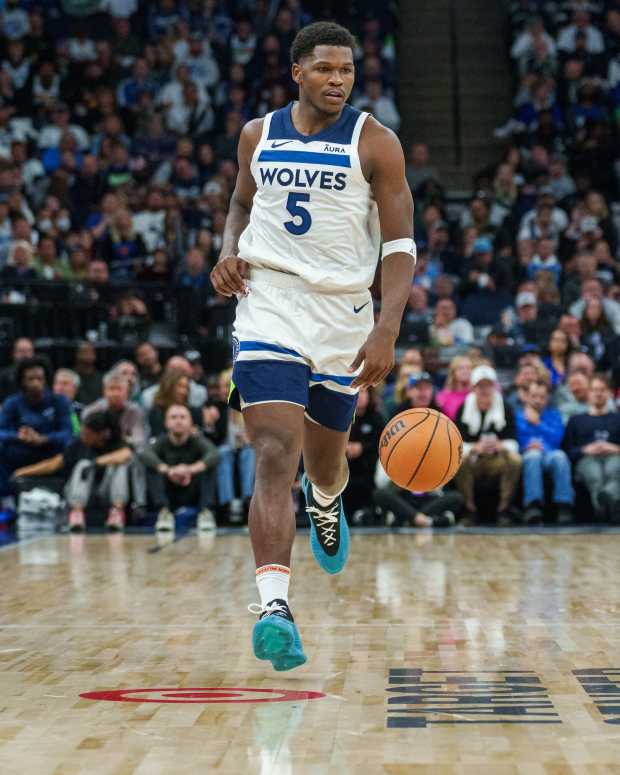 Minnesota Timberwolves guard Anthony Edwards (5) is guarded by Miami Heat forward Duncan Robinson (55).