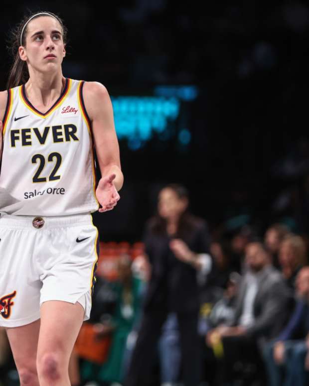 Indiana Fever guard Caitlin Clark (22) applauds while looking at the scoreboard in the third quarter against the New York Liberty at Barclays Center. 