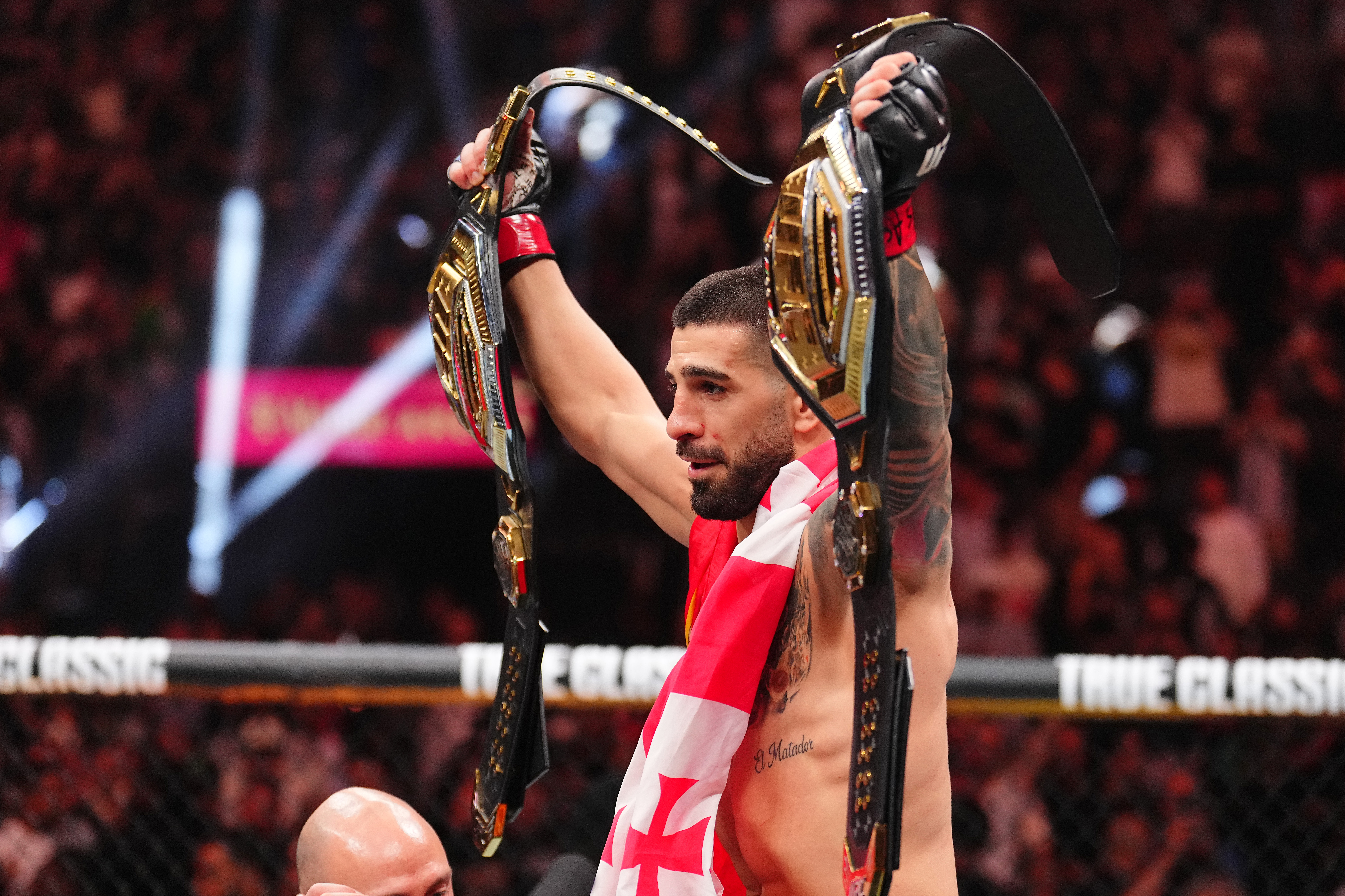 Ilia Topuria posing for photos with the UFC belt