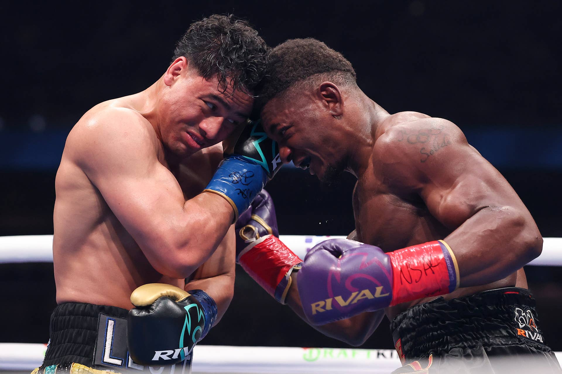Christian Mbilli in purple gloves pressing Lester Martinez in their 2025 boxing bout