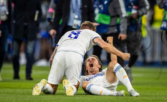 Real Madrid teammates Toni Kroos (left) and Luka Modric pictured celebrating on the field after winning the 2022 UEFA Champions League final against Liverpool at the Stade de France