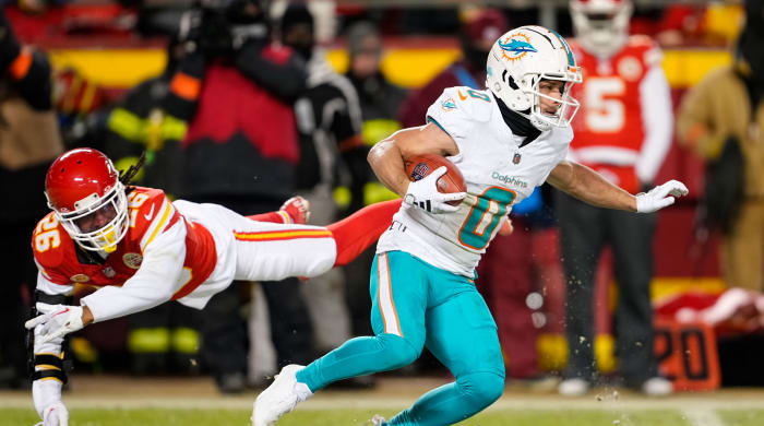 Dolphins wide receiver Braxton Berrios returns a kickoff as Chiefs safety Deon Bush fails to tackle him during a 2024 AFC wild card game.