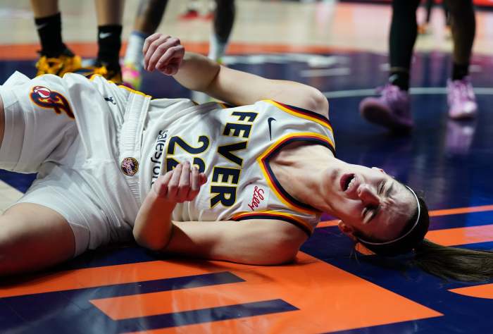 May 14, 2024; Uncasville, Connecticut, USA; Indiana Fever guard Caitlin Clark (22) falls to the floor after a blocked shot by guard Rachel Banham (1) (not pictured) in the second quarter at Mohegan Sun Arena.