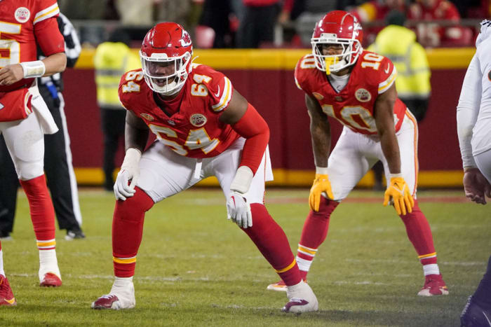 Kansas City Chiefs offensive tackle Wanya Morris (64) and running back Isiah Pacheco (10) at the line of scrimmage against the Cincinnati Bengals during the game at GEHA Field at Arrowhead Stadium.