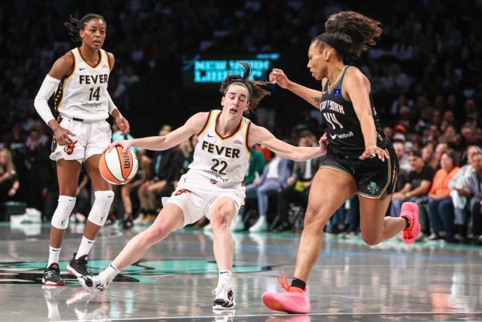 Indiana Fever guard Caitlin Clark (22) looks to drive past New York Liberty forward Betnijah Laney-Hamilton (44) in the first quarter at Barclays Center.