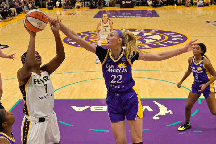 May 24, 2024; Los Angeles, California, USA; Los Angeles Sparks forward Cameron Brink (22) blocks a shot by Indiana Fever forward Aliyah Boston (7) in the first half at Crypto.com Arena.