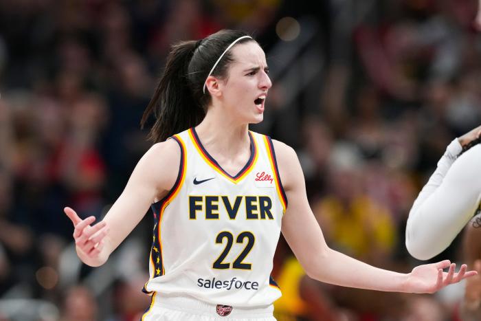 Indiana Fever guard Caitlin Clark (22) talks to Seattle Storm guard Victoria Vivians (35) following being run into after making a three-pointer, Thursday, May 30, 2024, during the WNBA game at Gainbridge Fieldhouse in Indianapolis. 