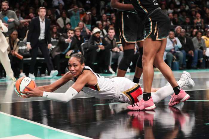 Las Vegas Aces forward A’ja Wilson falls to the floor with the ball during Game 3 of the 2023 WNBA Finals against the New York Liberty at Barclays Center.
