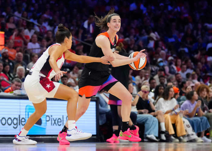 July 20, 2024; Phoenix, Ariz., U.S.; WNBA Team guard Caitlin Clark drives against USA Team guard Kelsey Plum during the WNBA All-Star Game. 